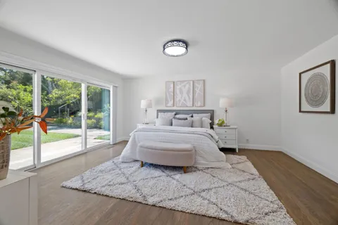 a spacious bedroom with a large bed and a large window