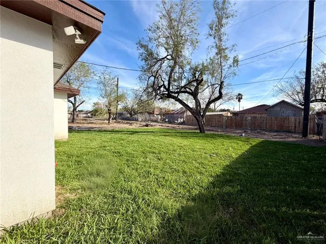 a view of yard with swimming pool and green space