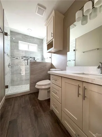 a bathroom with a sink toilet a mirror and shower