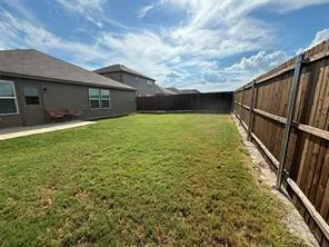 a view of backyard with seating area