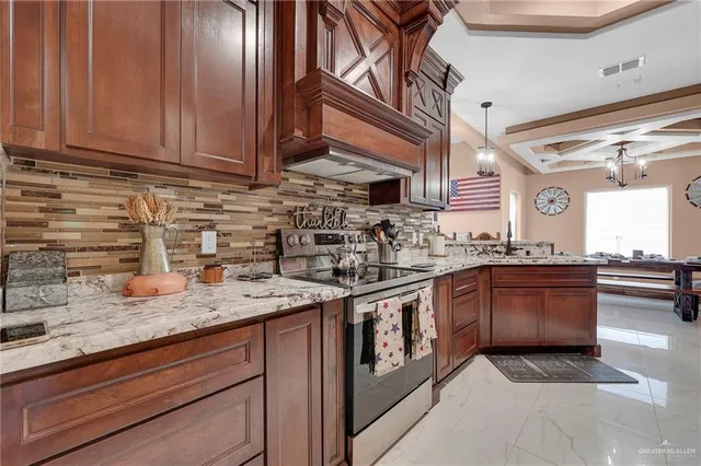 a kitchen with stainless steel appliances granite countertop a sink stove and cabinets