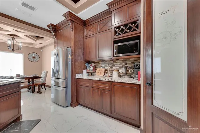 a kitchen with stainless steel appliances a stove and a refrigerator