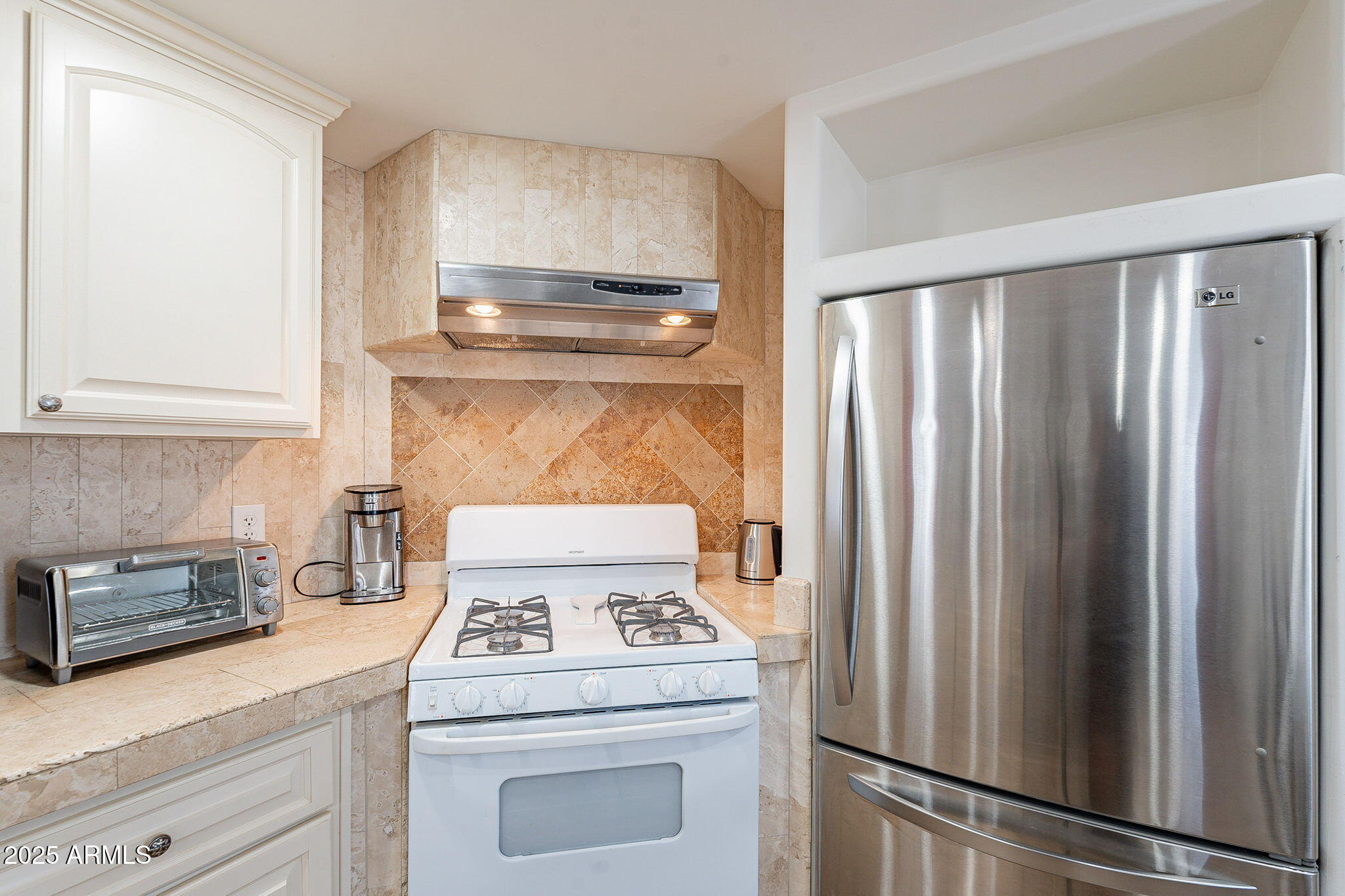 15606 South Gilbert Road, Unit 63 Chandler, AZ 85225 - Photo 10 of 21 a kitchen with a stove and a refrigerator