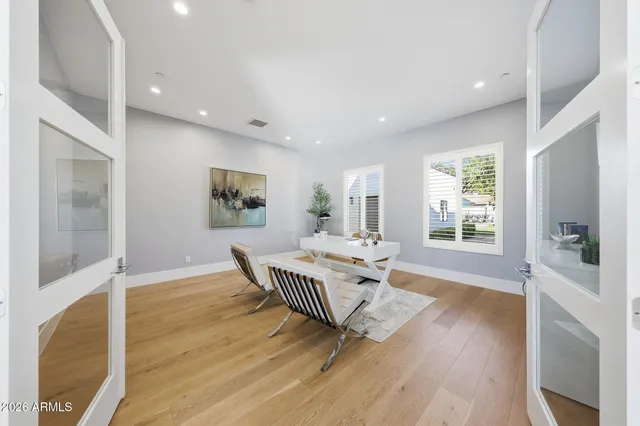 a large kitchen with a large counter top stainless steel appliances and cabinets