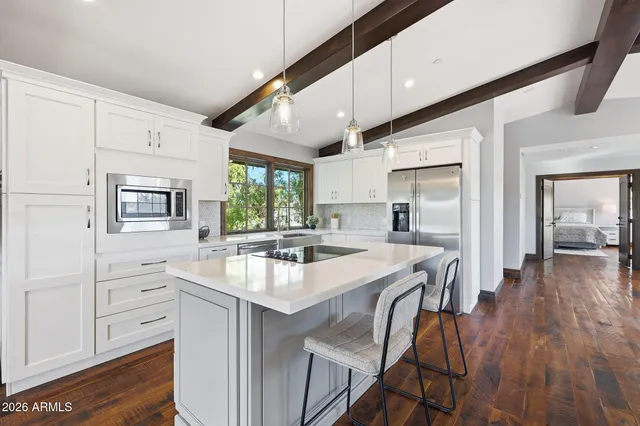a bedroom with a large bed and a large window