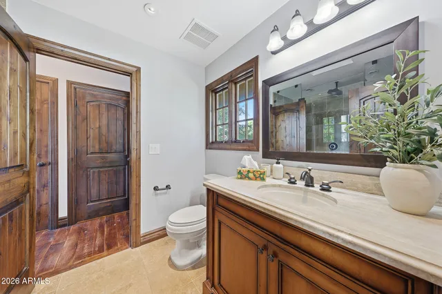 a living room with patio furniture and a potted plant