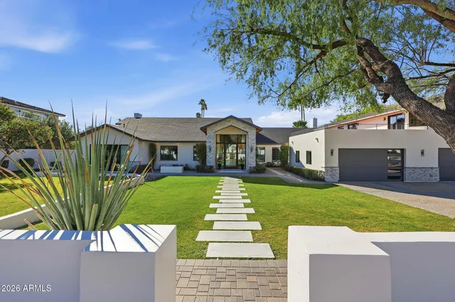 a front view of house with yard and green space