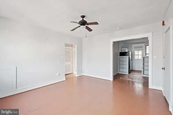 a view of a hallway with wooden floor and closet