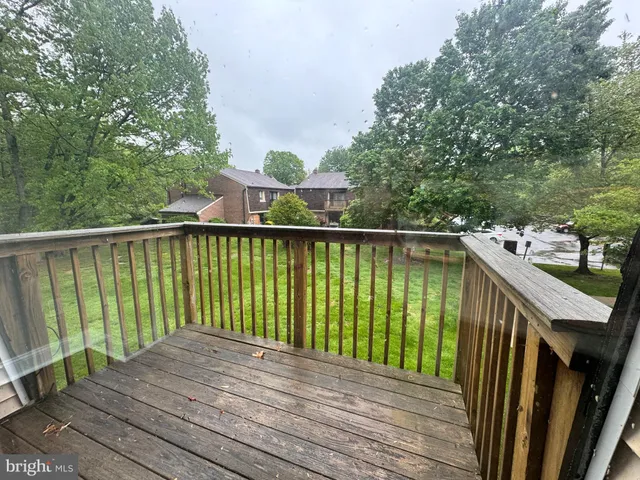 a balcony with wooden floor and outdoor space