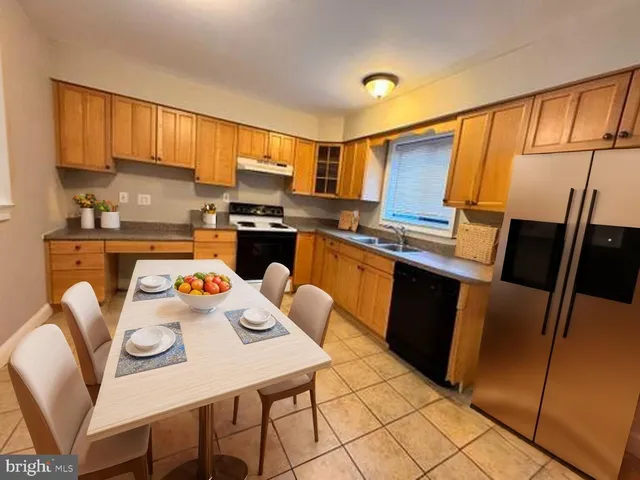 a kitchen with cabinets a counter space and appliances