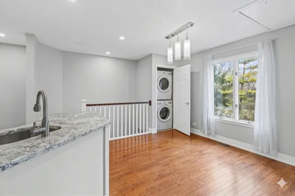 a kitchen with wooden floors and white appliances