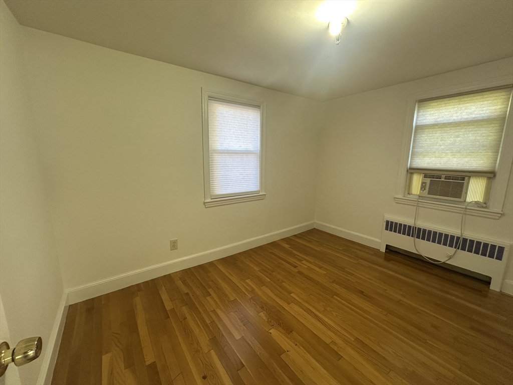 206 Adams Street, Unit 206 Newton, MA 02458 - Photo 12 of 37 a view of an empty room with wooden floor and a window