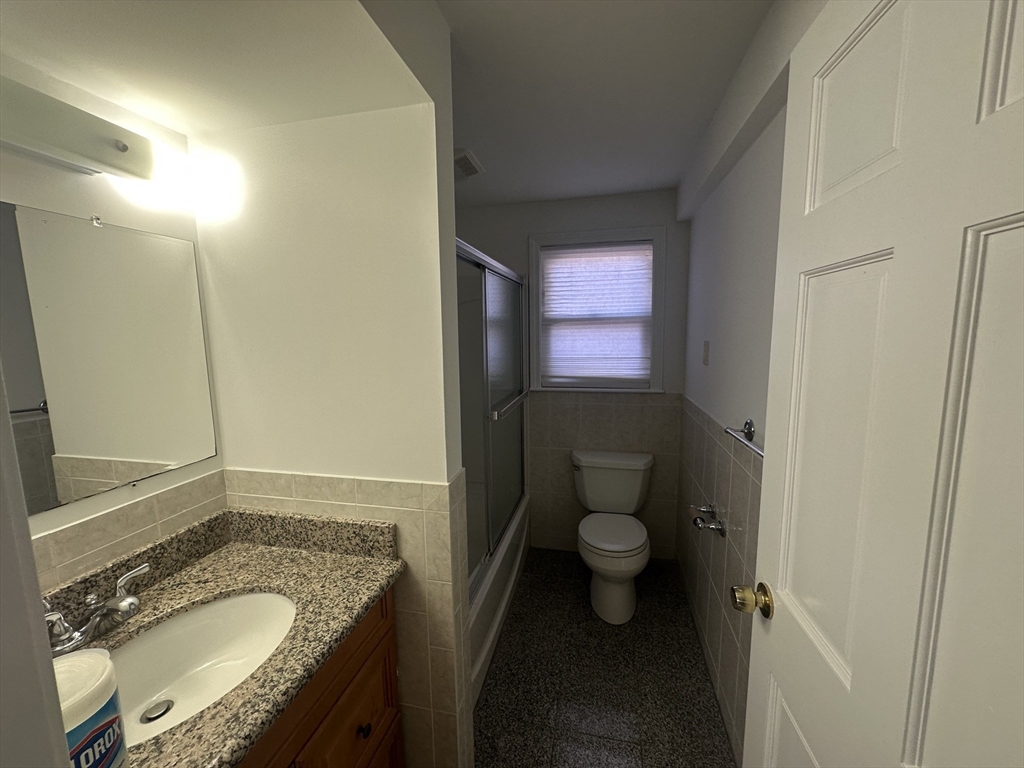 206 Adams Street, Unit 206 Newton, MA 02458 - Photo 17 of 37 a bathroom with a granite countertop sink and a mirror