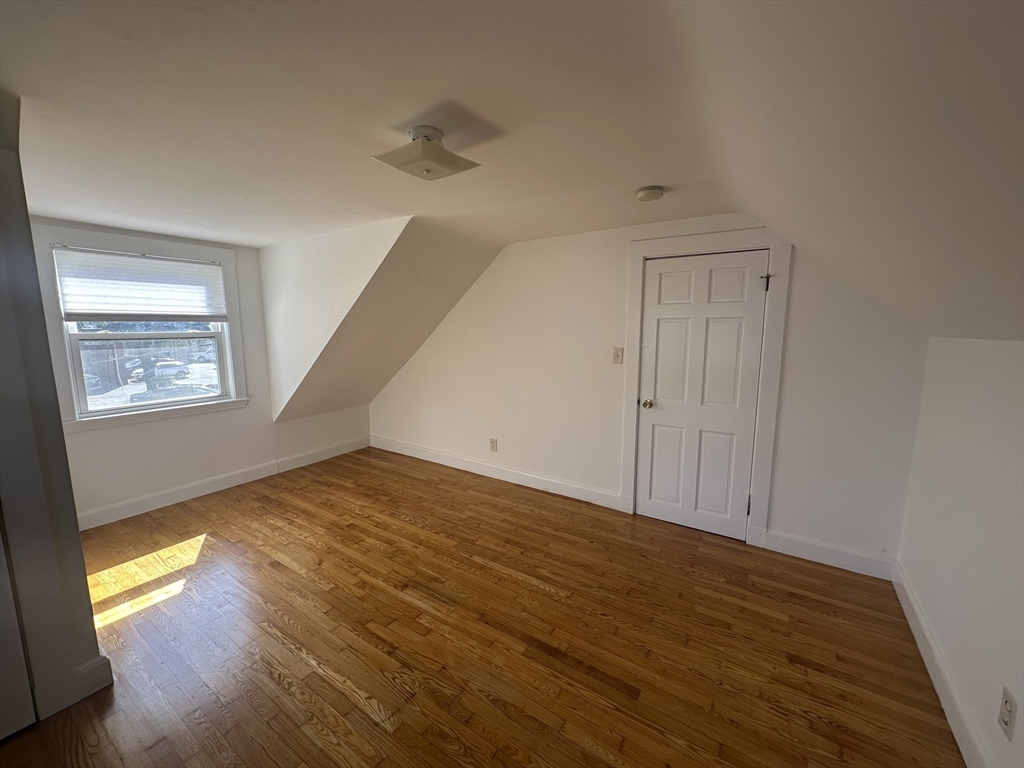 206 Adams Street, Unit 206 Newton, MA 02458 - Photo 21 of 37 a view of an empty room and wooden floor