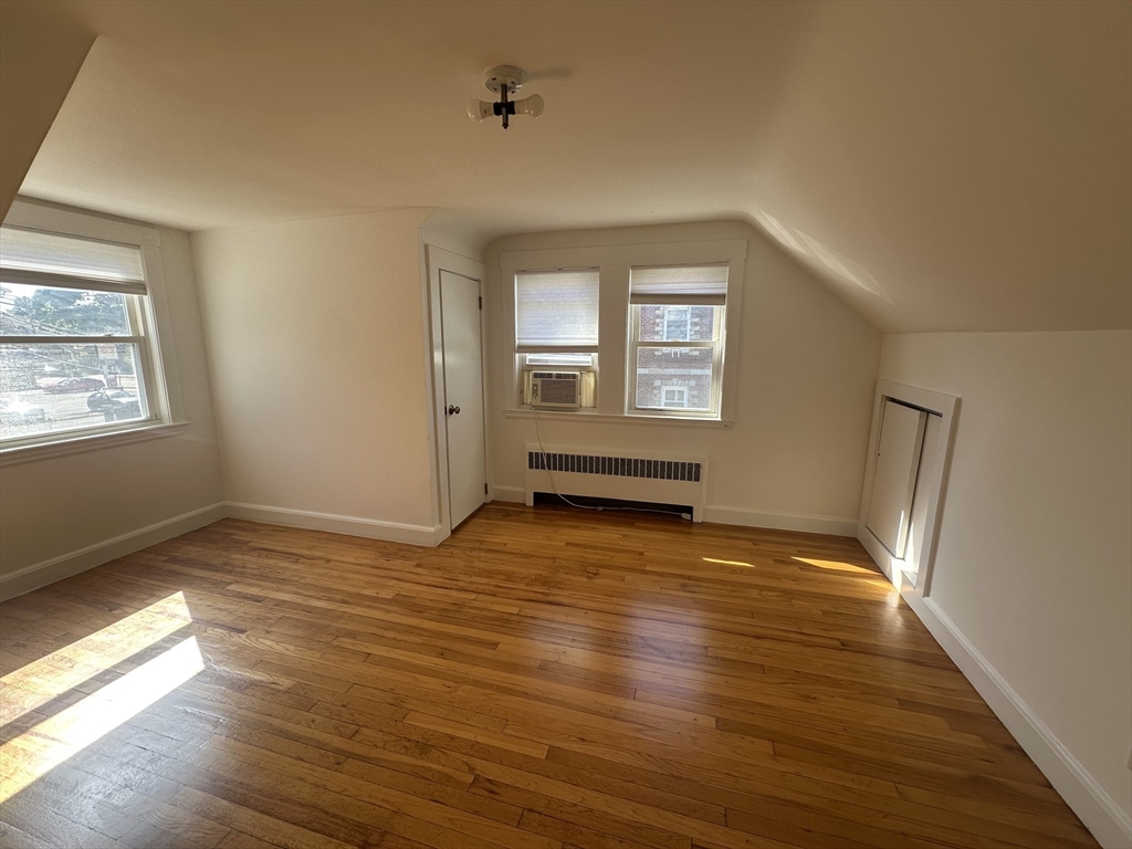 206 Adams Street, Unit 206 Newton, MA 02458 - Photo 24 of 37 a view of an empty room with wooden floor and a window