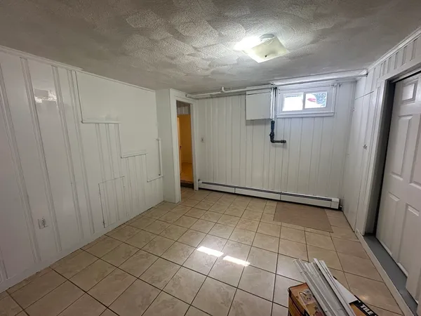 a view of a kitchen with white cabinets