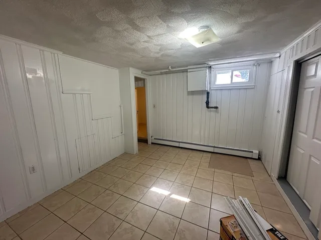 a view of a kitchen with white cabinets
