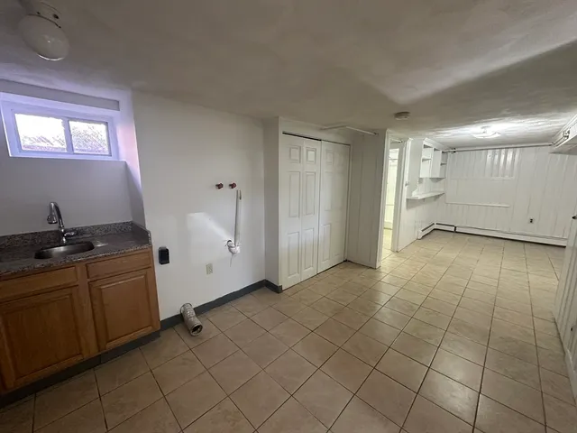 a kitchen with a sink a counter and cabinets
