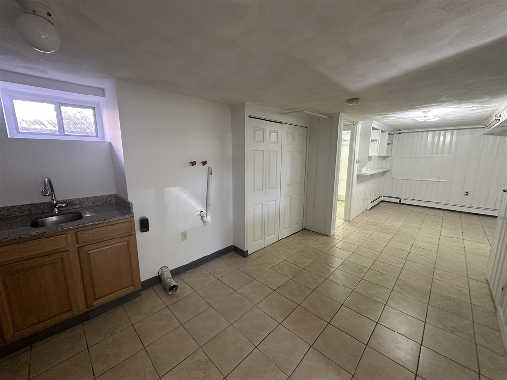 206 Adams Street, Unit 206 Newton, MA 02458 - Photo 29 of 37 a view of a kitchen with white cabinets