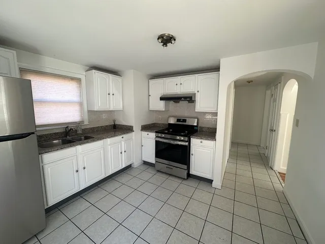 a kitchen with a sink a stove and refrigerator