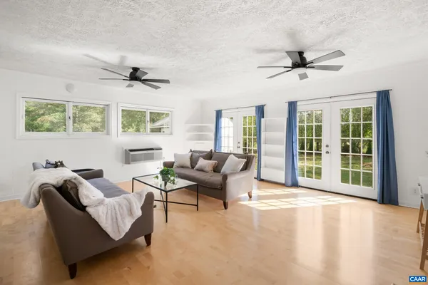 a kitchen with stainless steel appliances granite countertop a sink cabinets and living room view