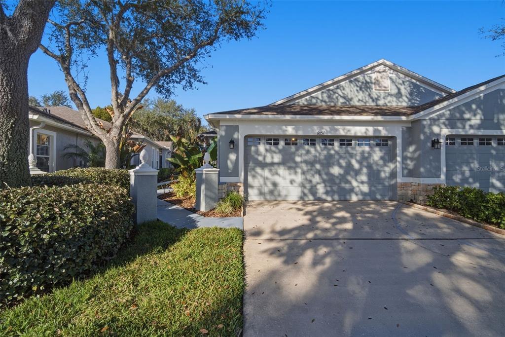 6057 Sandhill Ridge Drive Lithia, FL 33547 - Photo 1 of 83 a view of a house with a small yard and a large tree