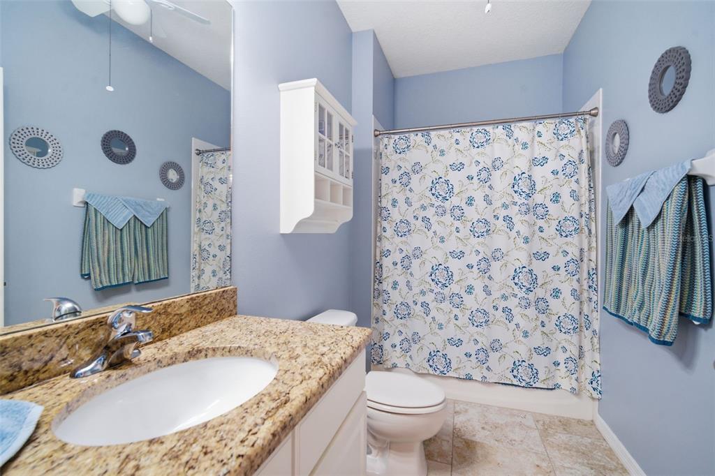 6057 Sandhill Ridge Drive Lithia, FL 33547 - Photo 39 of 83 a bathroom with a granite countertop sink and a mirror