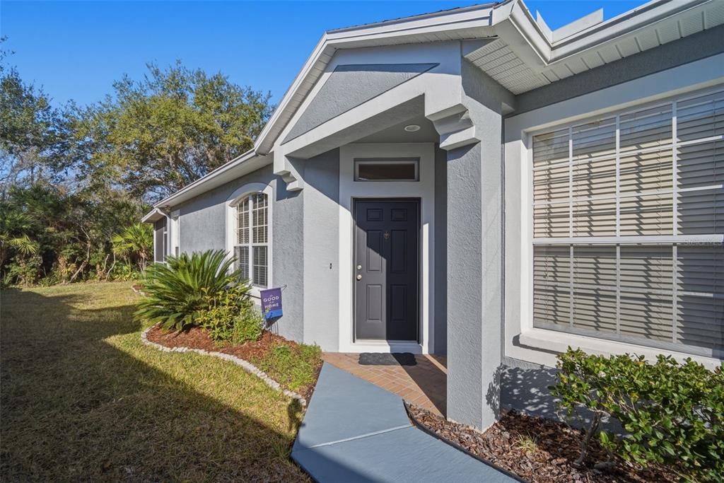 6057 Sandhill Ridge Drive Lithia, FL 33547 - Photo 8 of 83 a front view of a house with garden