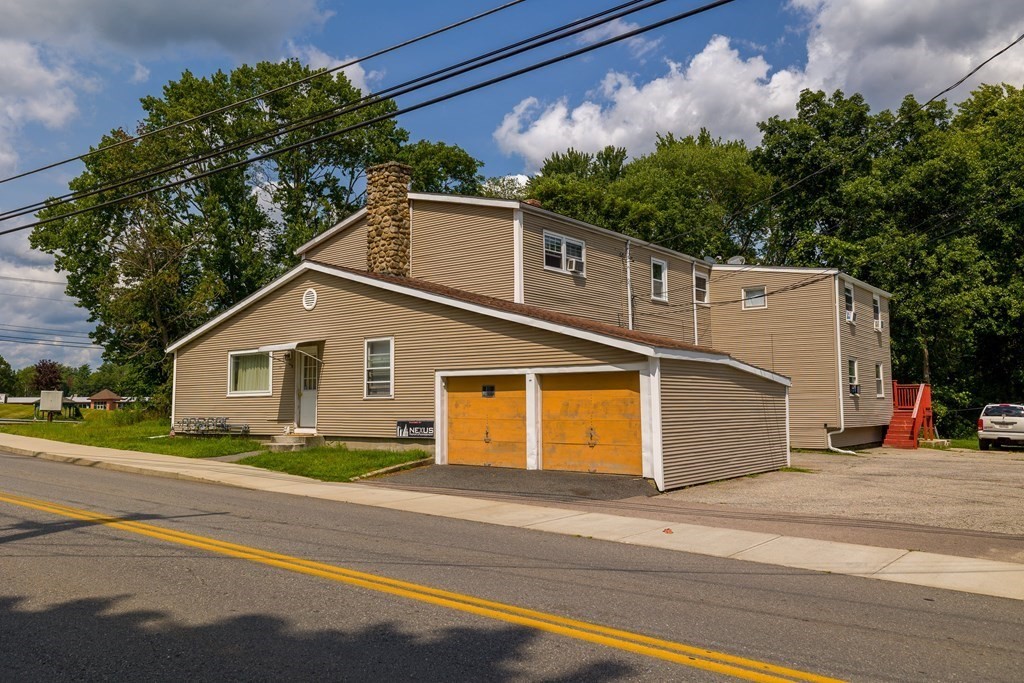 102 Mendon Street Blackstone, MA 01504 - Photo 1 of 41 a front view of a house with a yard and garage