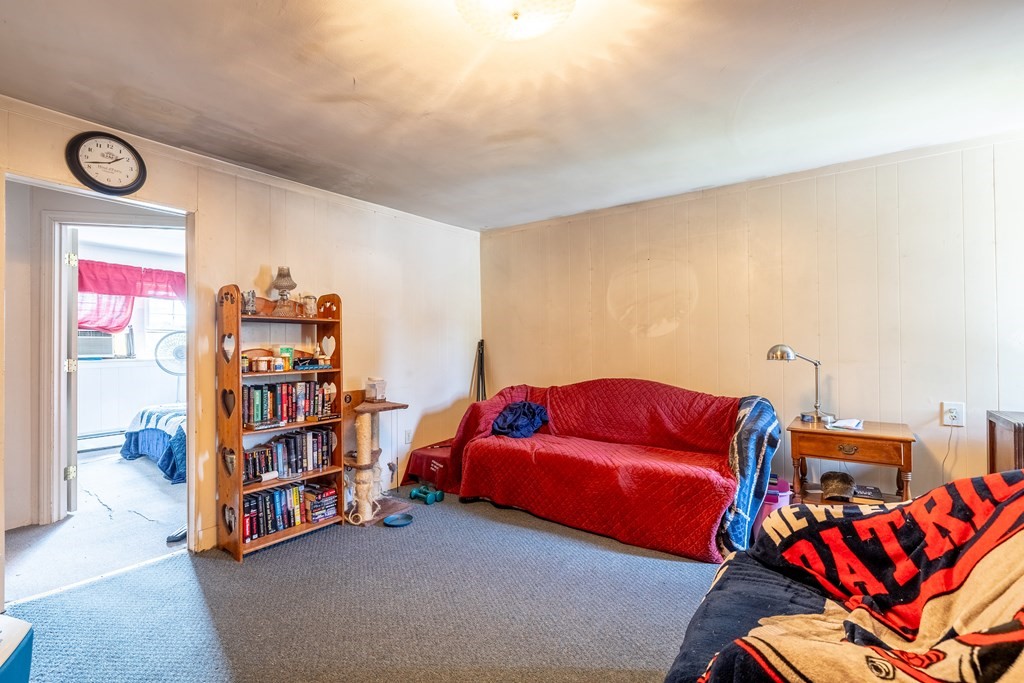 102 Mendon Street Blackstone, MA 01504 - Photo 18 of 41 a bedroom with furniture and a book shelf