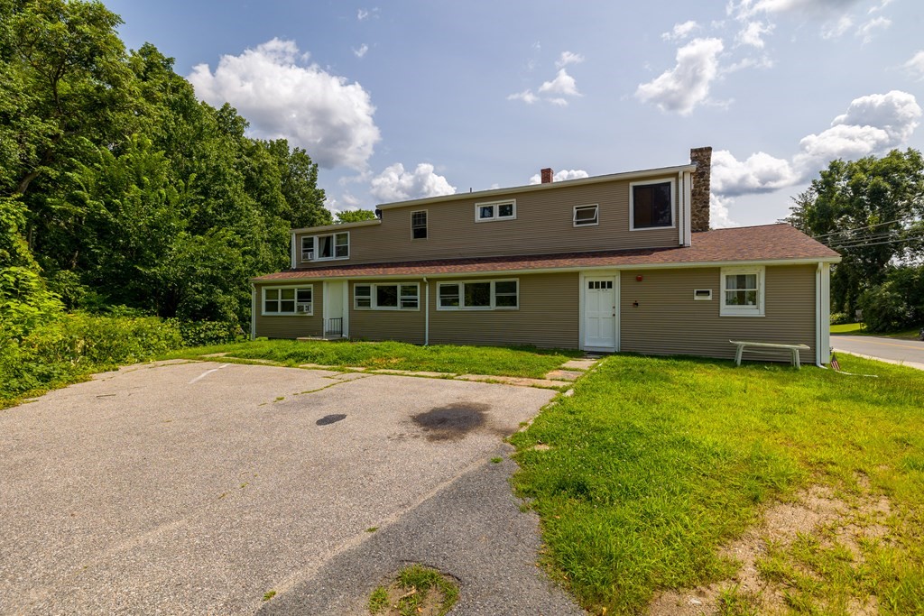 102 Mendon Street Blackstone, MA 01504 - Photo 3 of 41 a front view of a house with a garden