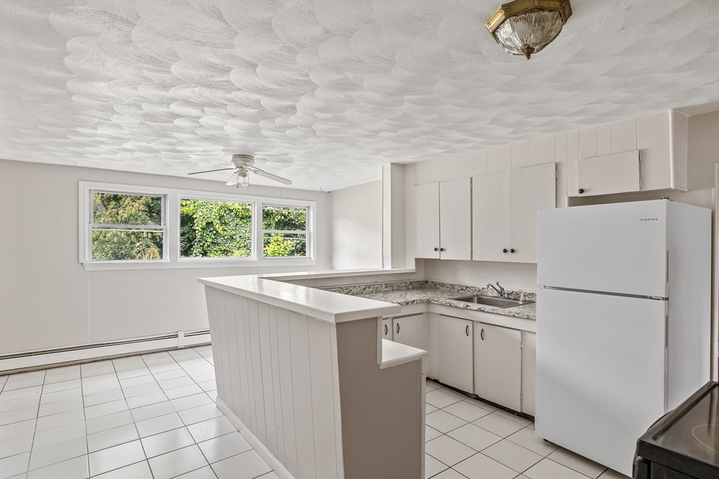 102 Mendon Street Blackstone, MA 01504 - Photo 4 of 41 a kitchen with appliances cabinets and a sink