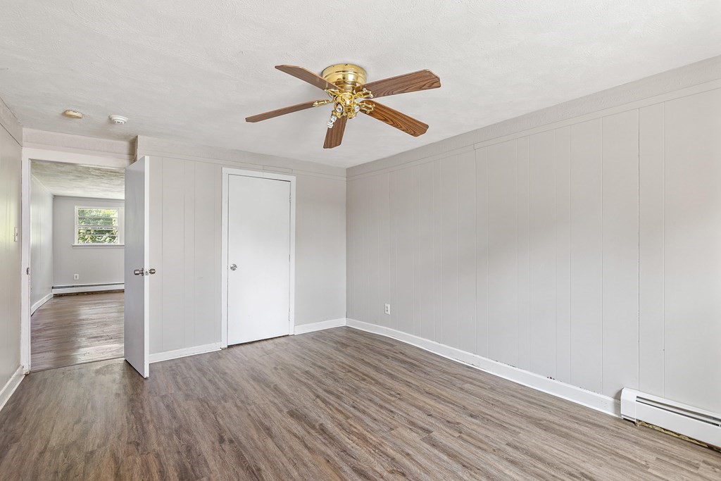 102 Mendon Street Blackstone, MA 01504 - Photo 9 of 41 a view of empty room with wooden floor and fan