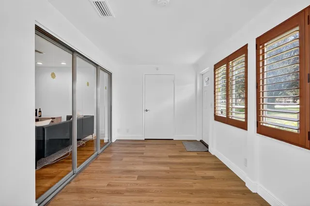 a view of a room with wooden floor and window