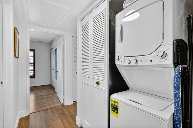 a view of washer and dryer with bathroom in the background