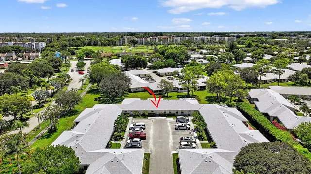 an aerial view of residential houses with outdoor space and street view