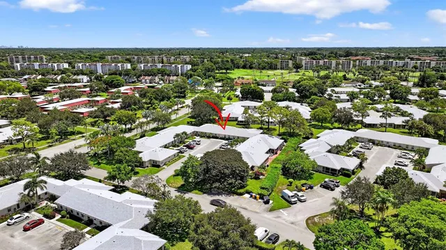 an aerial view of residential houses with outdoor space
