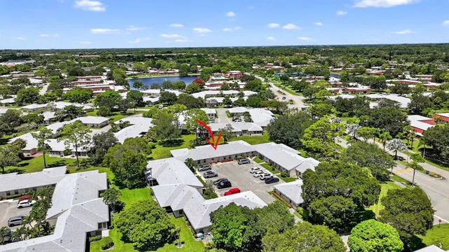 an aerial view of residential houses with outdoor space and trees