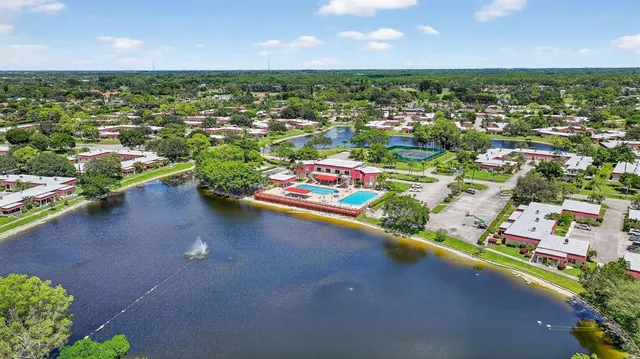 an aerial view of residential houses with outdoor space and street view