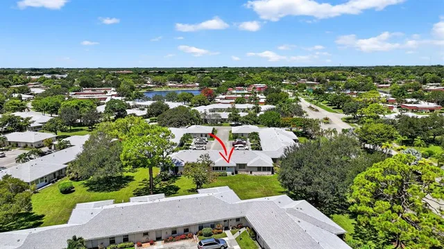 an aerial view of residential houses with outdoor space and trees