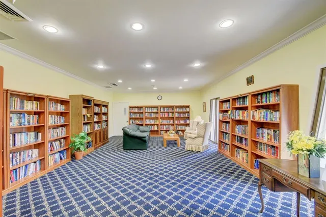 a view of a livingroom with furniture and book shelf