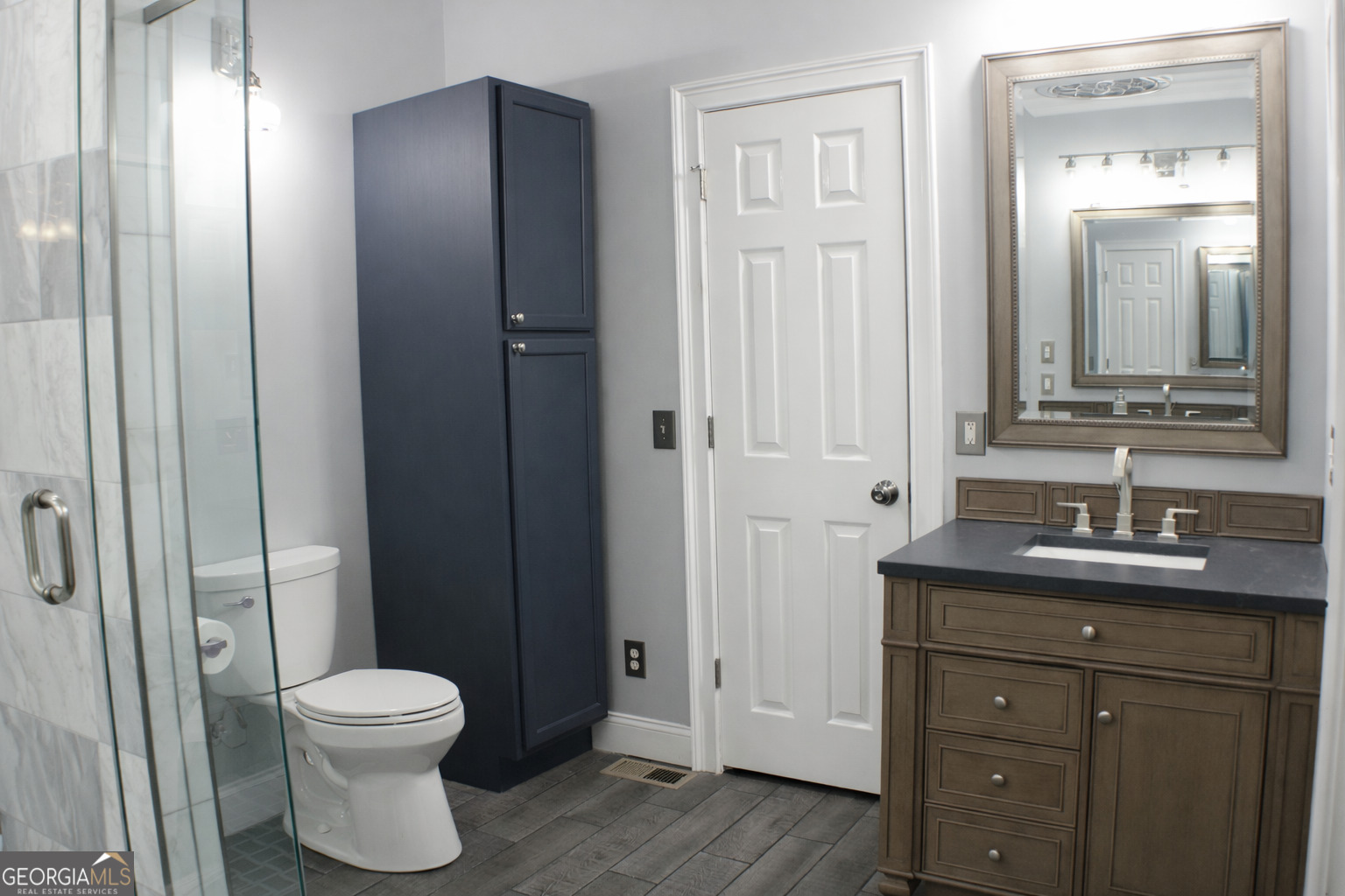 418 Flora Ext Avenue Rome, GA 30161 - Photo 15 of 29 a bathroom with a toilet a sink and mirror