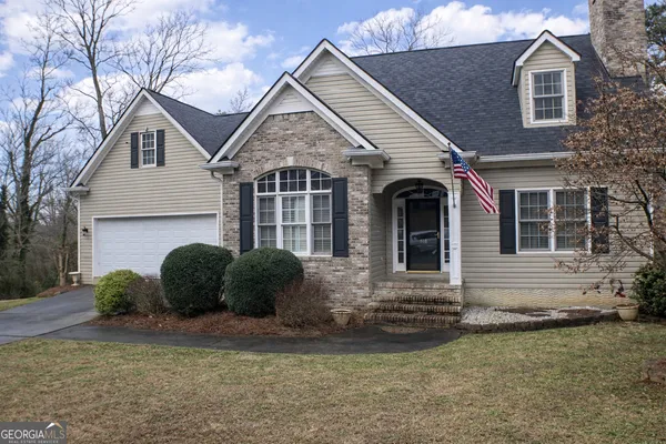 a front view of a house with a garden