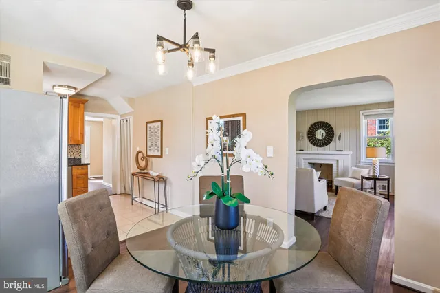 a dining room with furniture a chandelier and wooden floor