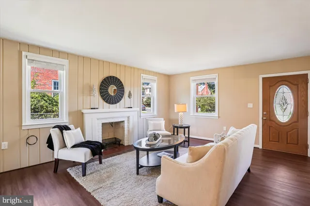 a living room with furniture a fireplace and a large window