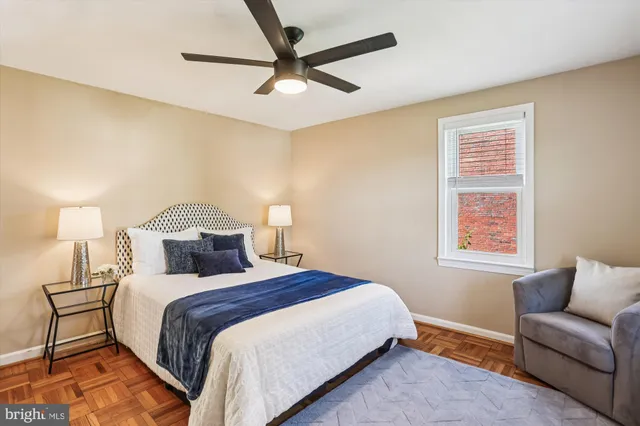 a bedroom with a bed and a lamp