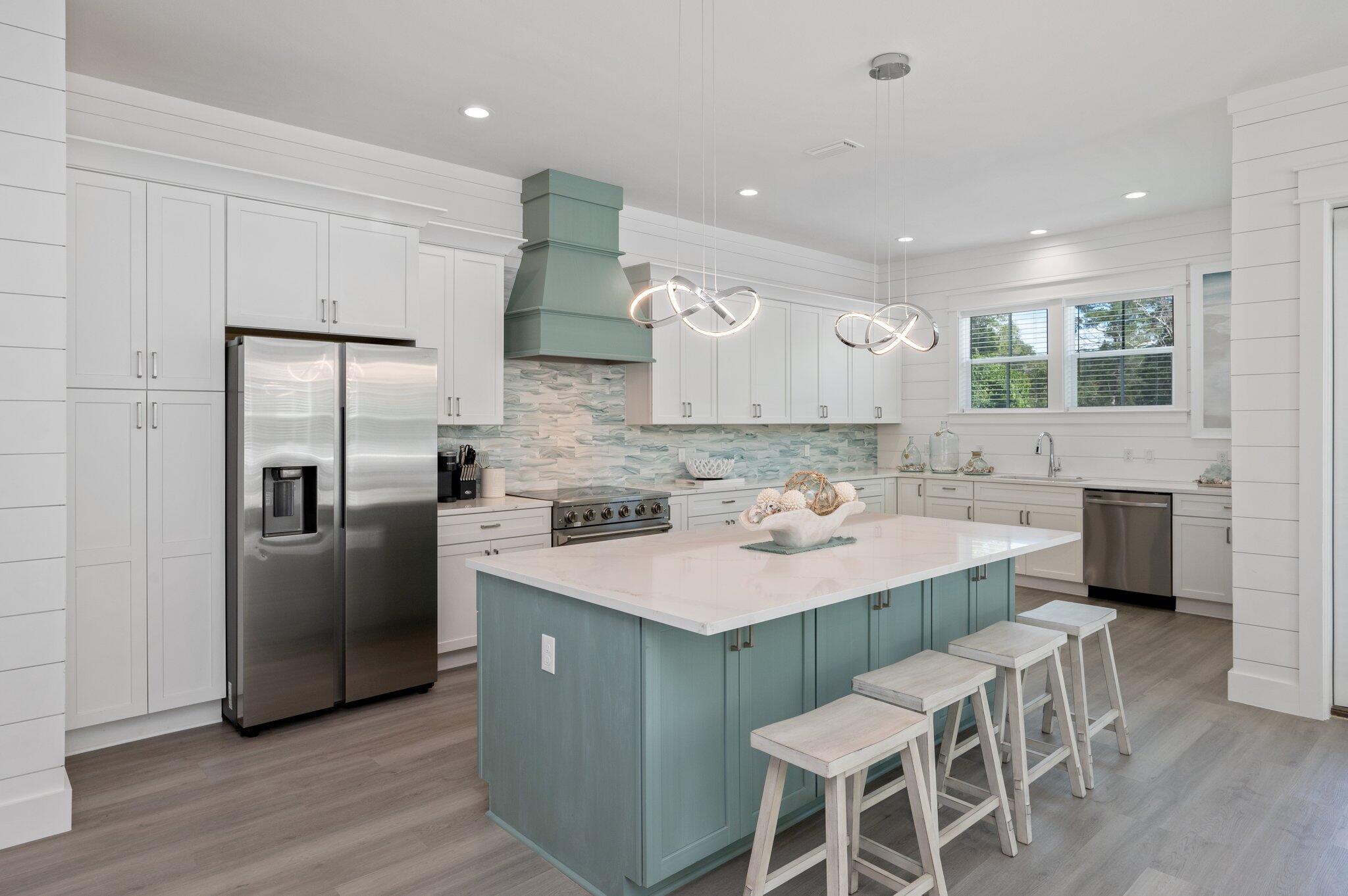 36 North Gulf Drive Santa Rosa Beach, FL 32459 - Photo 17 of 96 a kitchen with stainless steel appliances granite countertop a table chairs sink refrigerator and microwave