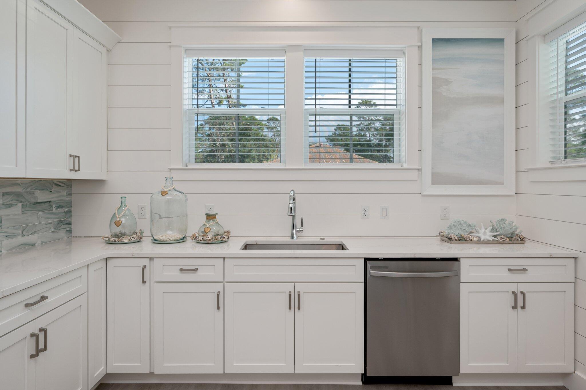36 North Gulf Drive Santa Rosa Beach, FL 32459 - Photo 18 of 96 a kitchen with white cabinets and a window