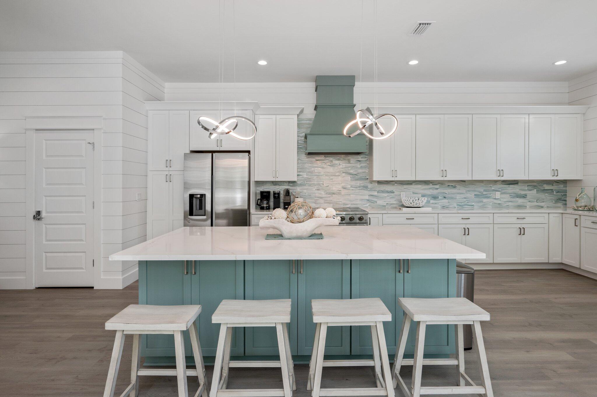 36 North Gulf Drive Santa Rosa Beach, FL 32459 - Photo 6 of 96 a kitchen with a dining table chairs cabinets and stainless steel appliances