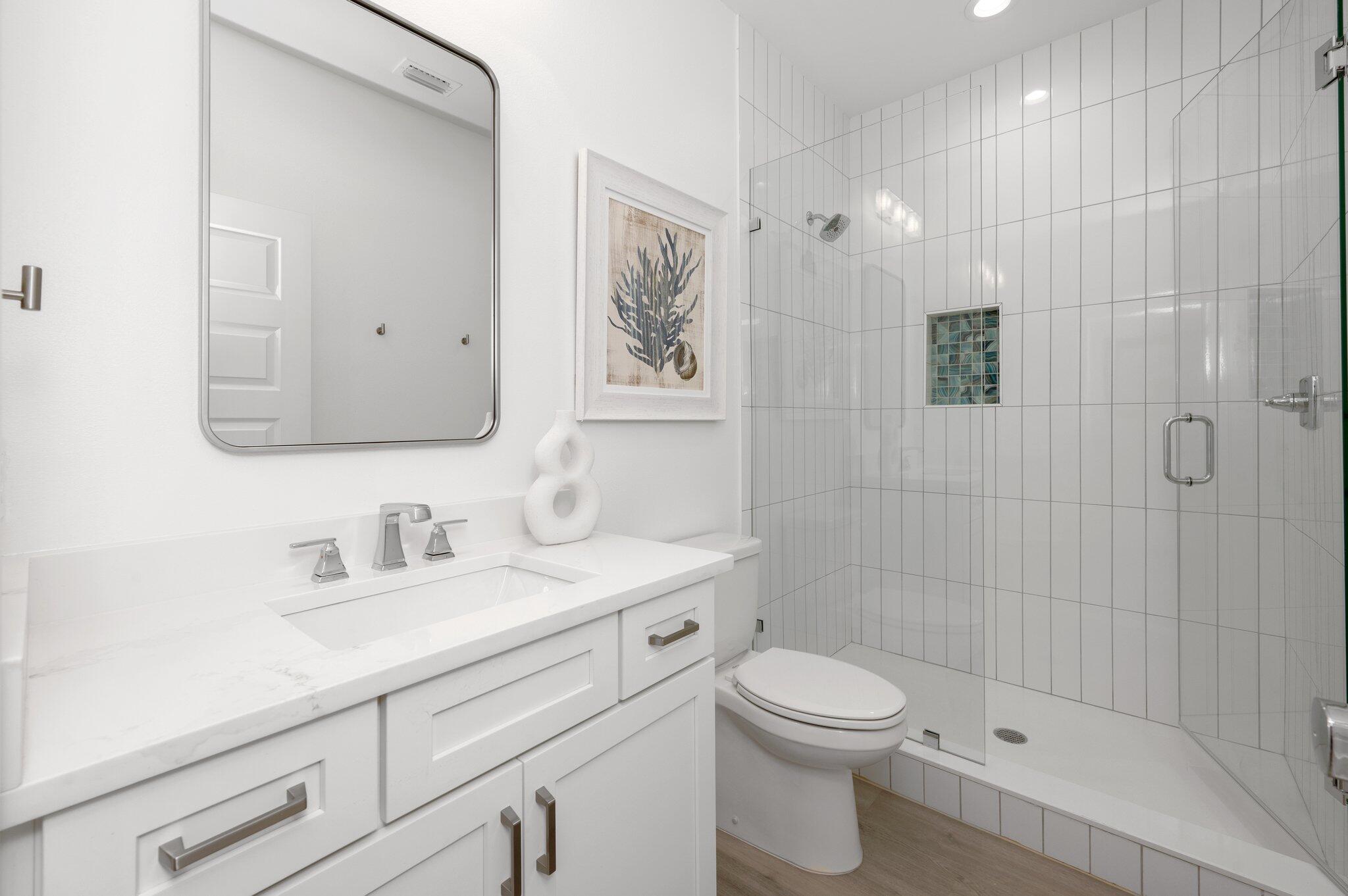 36 North Gulf Drive Santa Rosa Beach, FL 32459 - Photo 88 of 96 a bathroom with a toilet a sink a mirror a shower a vanity and window